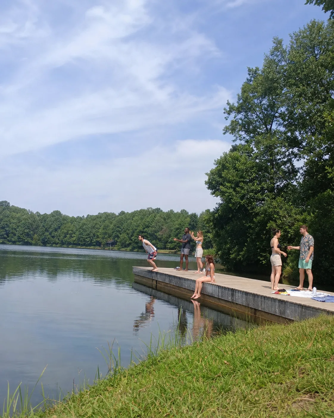 Alex hesitating at the edge of a lake dock with friends